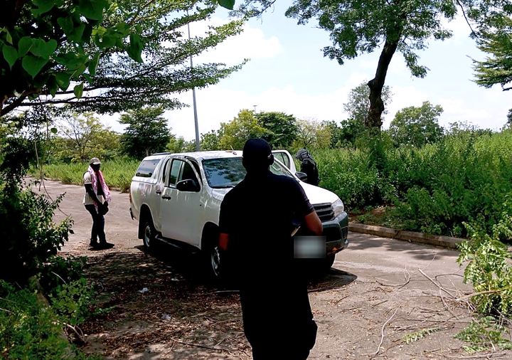 Trainees during a field scenario exercise beside a vehicle